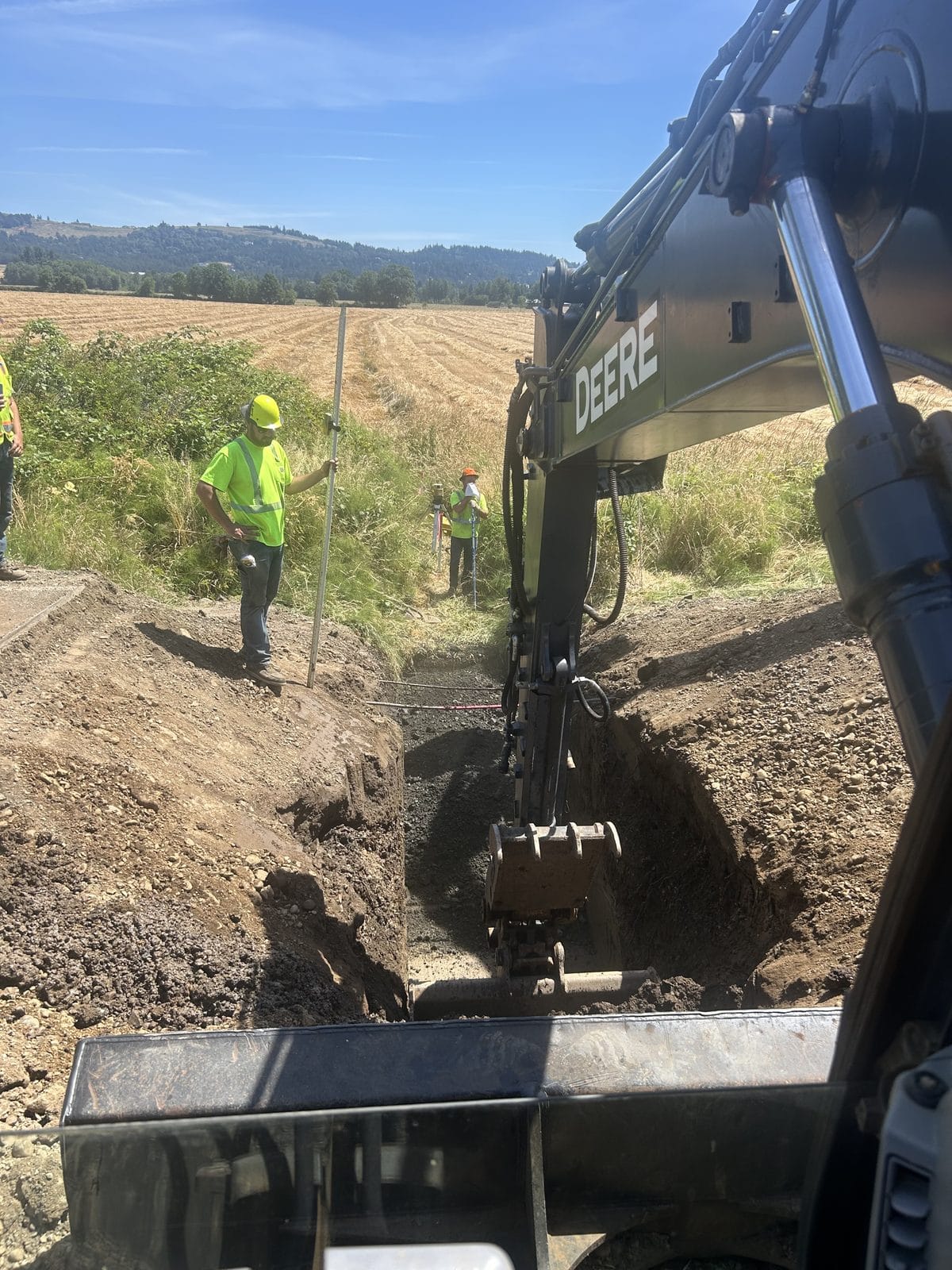 Iron Edge crew working a trench to grade