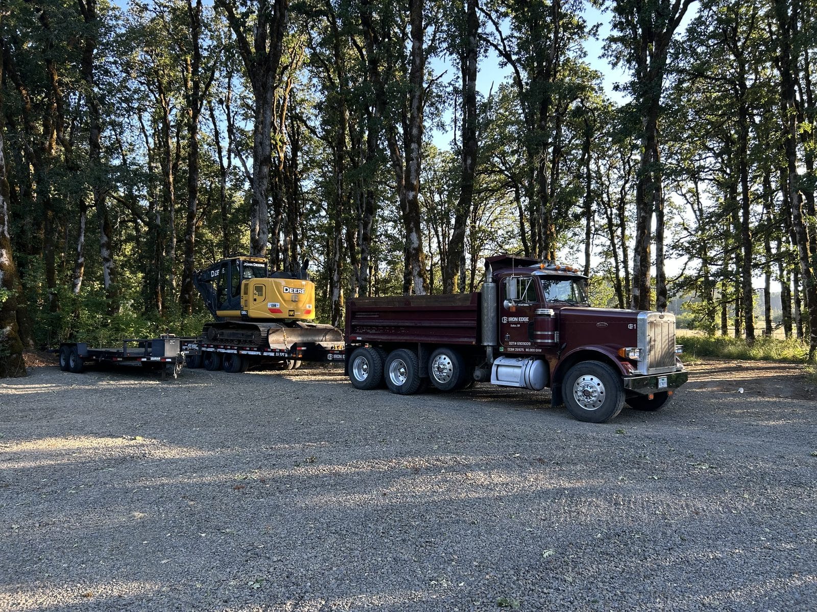 Dump truck and trailer loaded with the excavator